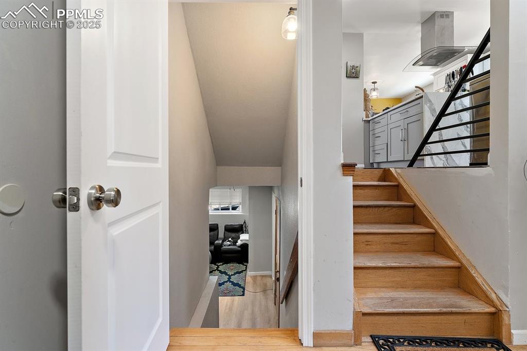 Image 34 of 41: Staircase featuring wood finished floors and baseboards