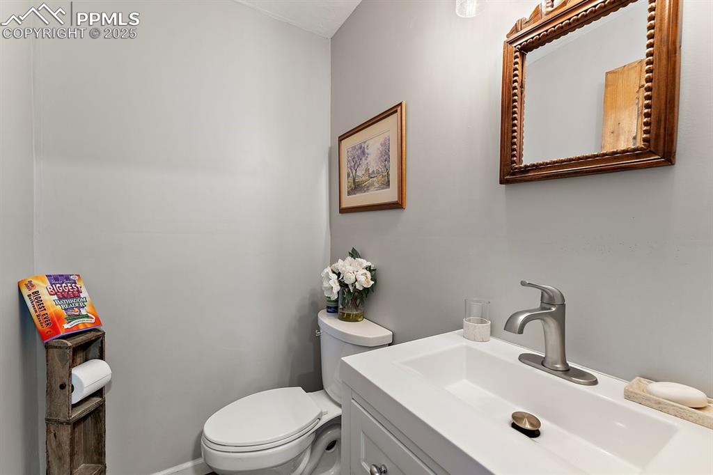 Image 35 of 41: Half bath with toilet and vanity