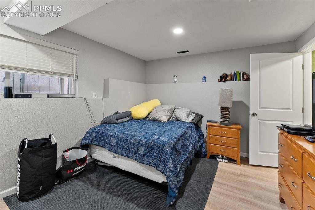 Image 37 of 41: Bedroom with light wood-style floors