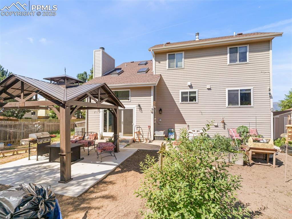 Image 40 of 41: Rear view of house featuring a gazebo, outdoor lounge area, a patio area, a
