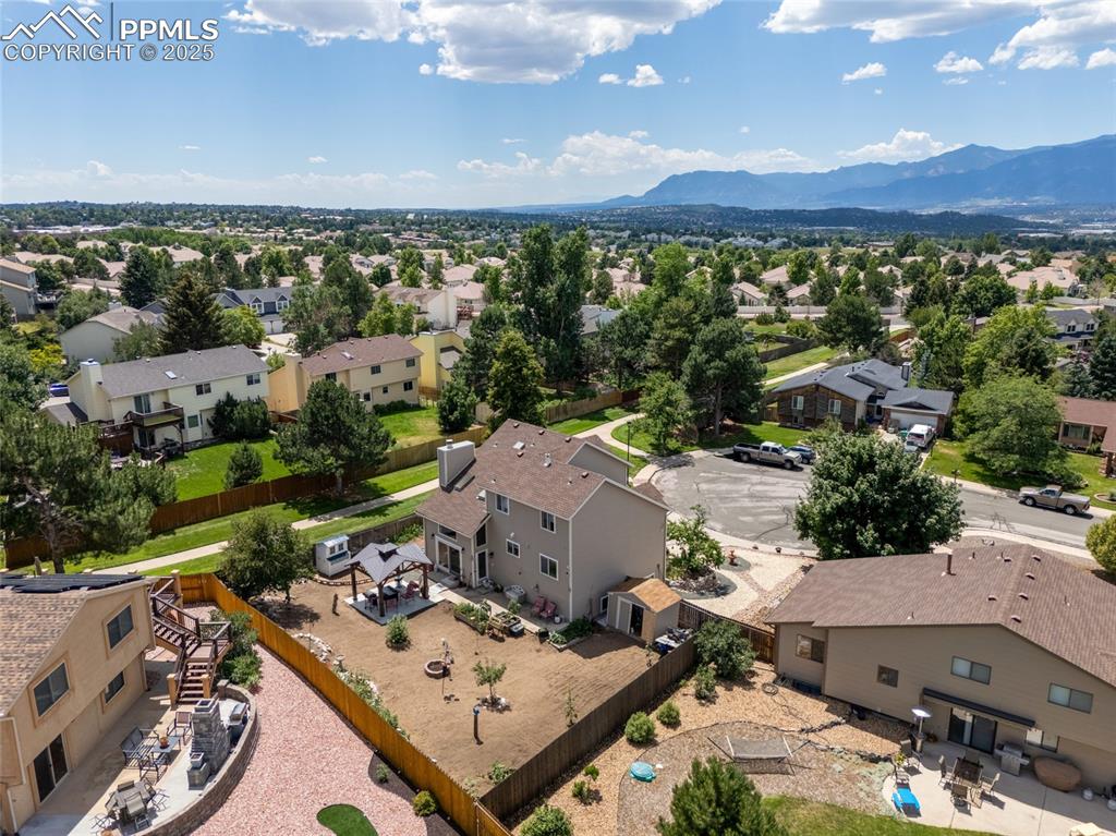 Image 5 of 41: Aerial perspective of suburban area featuring a mountainous background