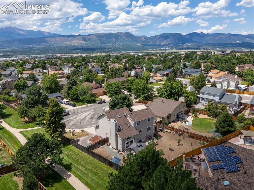 Image 6 of 41: Aerial view of residential area with a mountain backdrop