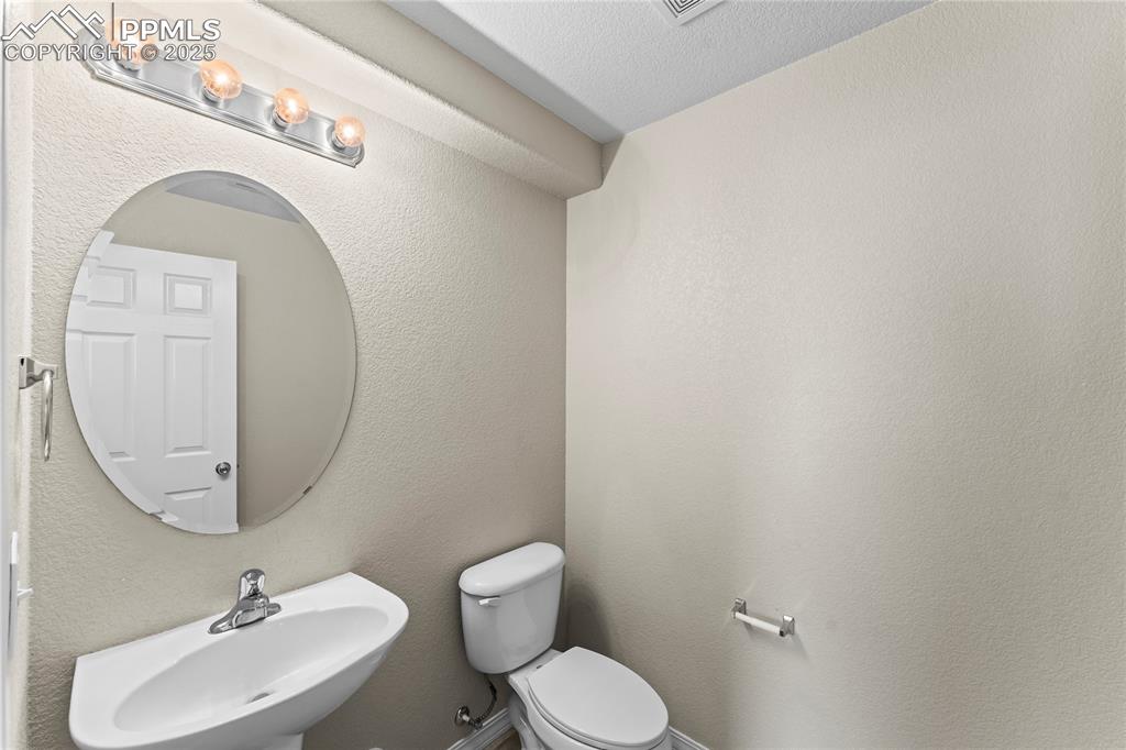 Image 10 of 30: Bathroom featuring a textured wall and a textured ceiling
