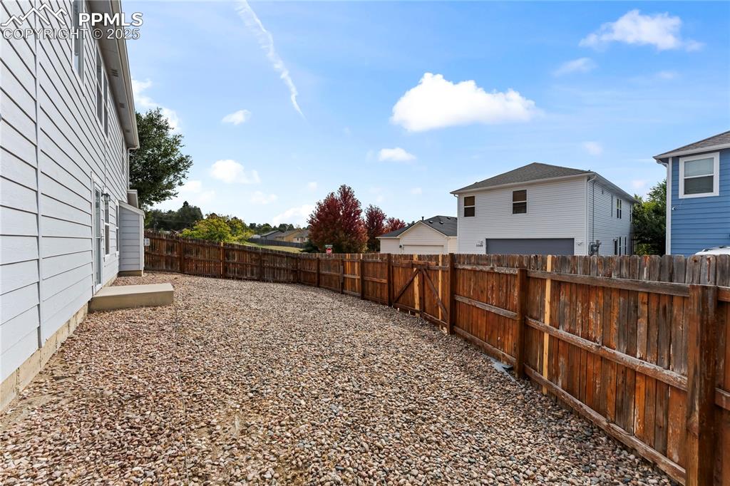 Image 28 of 30: View of fenced backyard