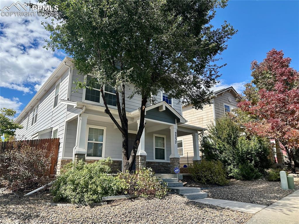 Image 3 of 30: View of front facade featuring stone siding and a porch