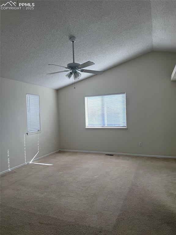 Image 12 of 34: Spare room featuring a ceiling fan, a textured ceiling, vaulted ceiling, ca