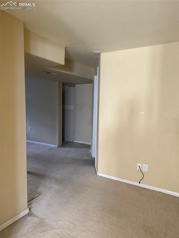 Image 24 of 34: Carpeted empty room featuring baseboards