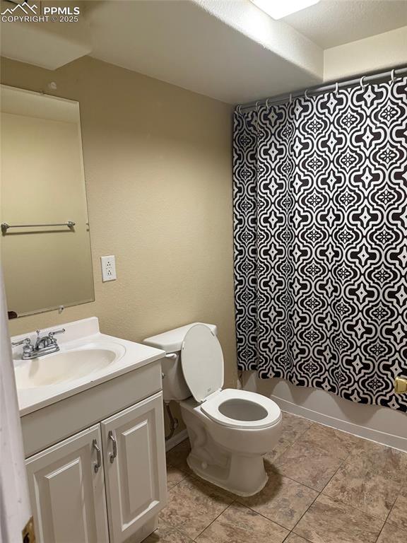 Image 25 of 34: Bathroom featuring toilet, vanity, and tile patterned flooring