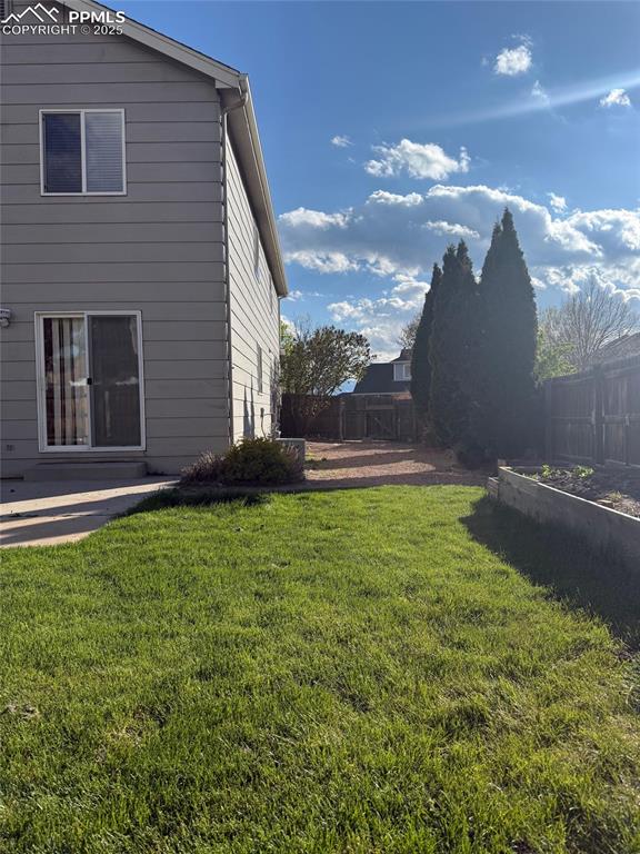 Image 30 of 34: View of yard with a garden