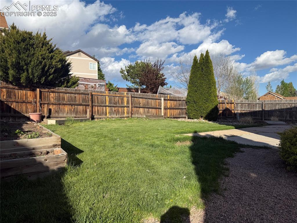 Image 32 of 34: View of yard with a garden