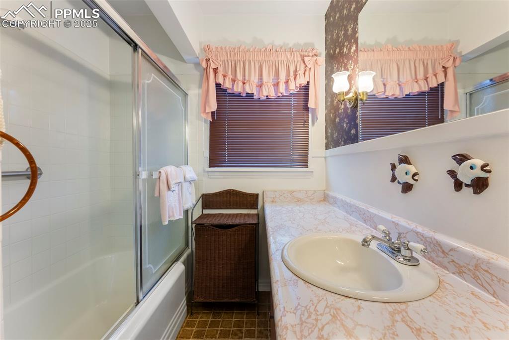 Image 11 of 30: Full bath featuring vanity, combined bath / shower with glass door, and dar