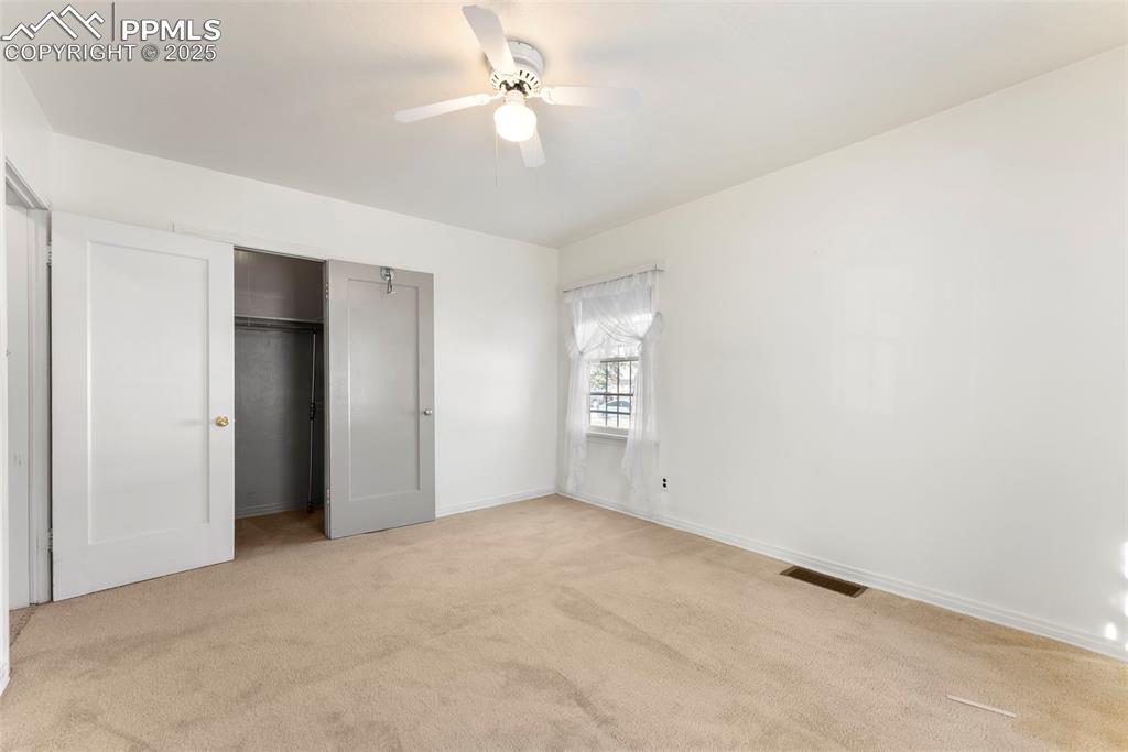 Image 15 of 30: Unfurnished bedroom featuring light colored carpet, a closet, and ceiling f