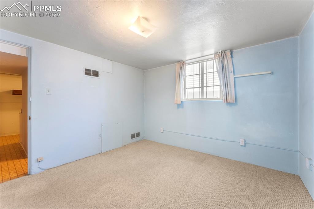 Image 22 of 30: Spare room with carpet and a textured ceiling