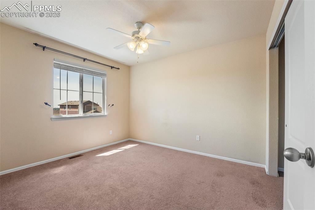 Image 25 of 39: Unfurnished room with carpet and ceiling fan