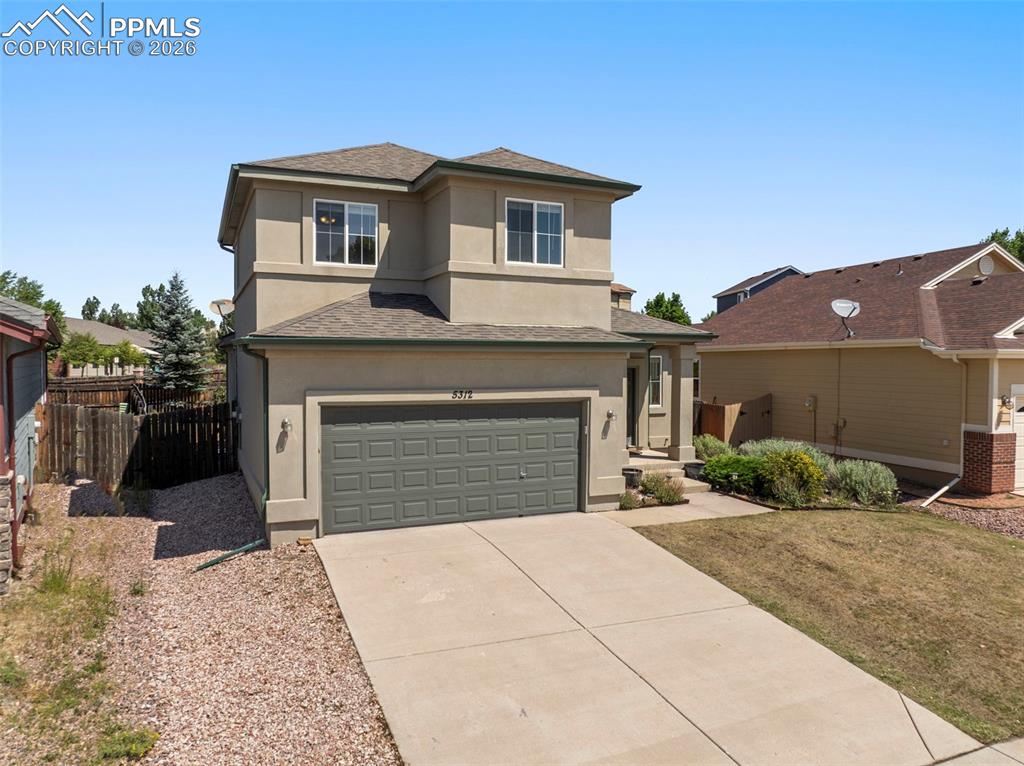 Image 3 of 39: View of front facade featuring a shingled roof, stucco siding, an attached 