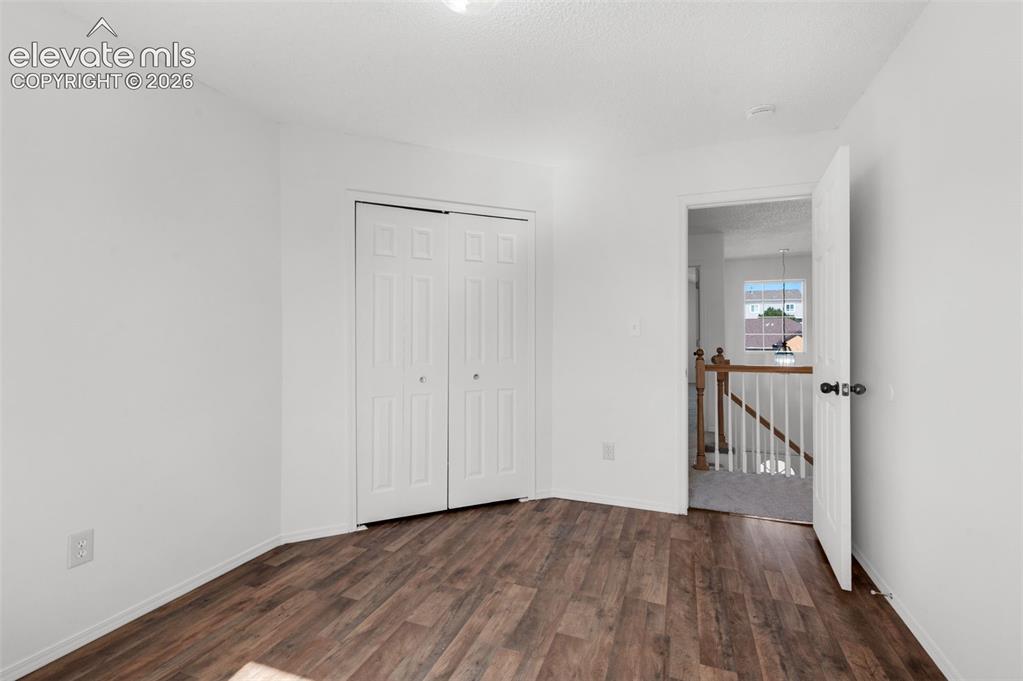 Image 28 of 48: White walls with wood-finish flooring