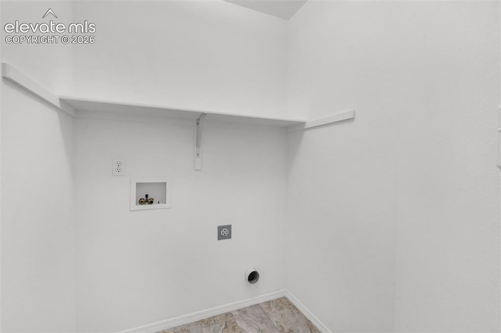 Image 32 of 48: Built-in shelving, laundry hook-ups, and patterned flooring