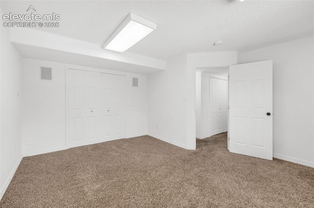 Image 37 of 48: Recessed ceiling speakers, bi-fold closet doors, wall-to-wall carpeting, an