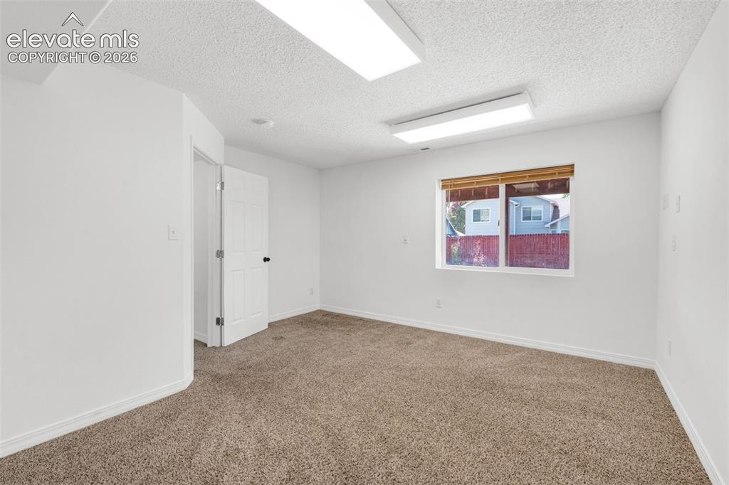 Image 38 of 48: Neutral-toned carpet flooring