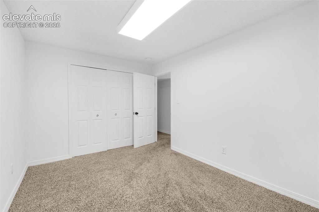 Image 41 of 48: Neutral-toned carpeting with white trim, white walls, and a white ceiling
