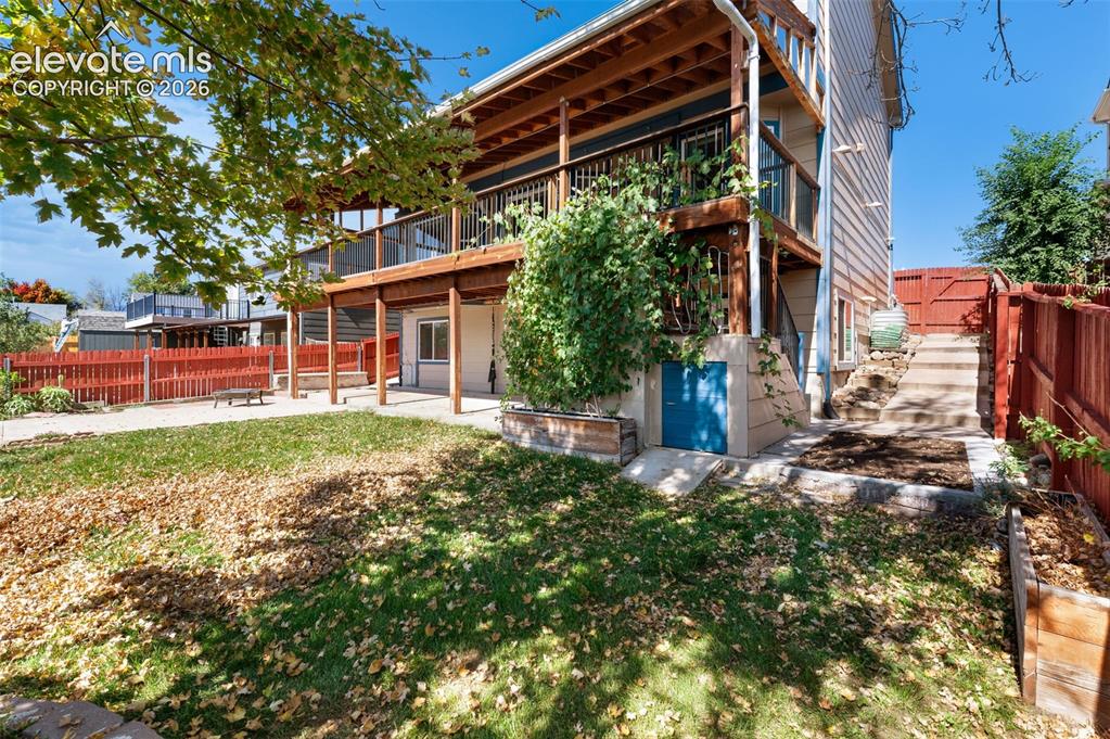 Image 42 of 48: Multi-level wood deck structure with a lower patio area