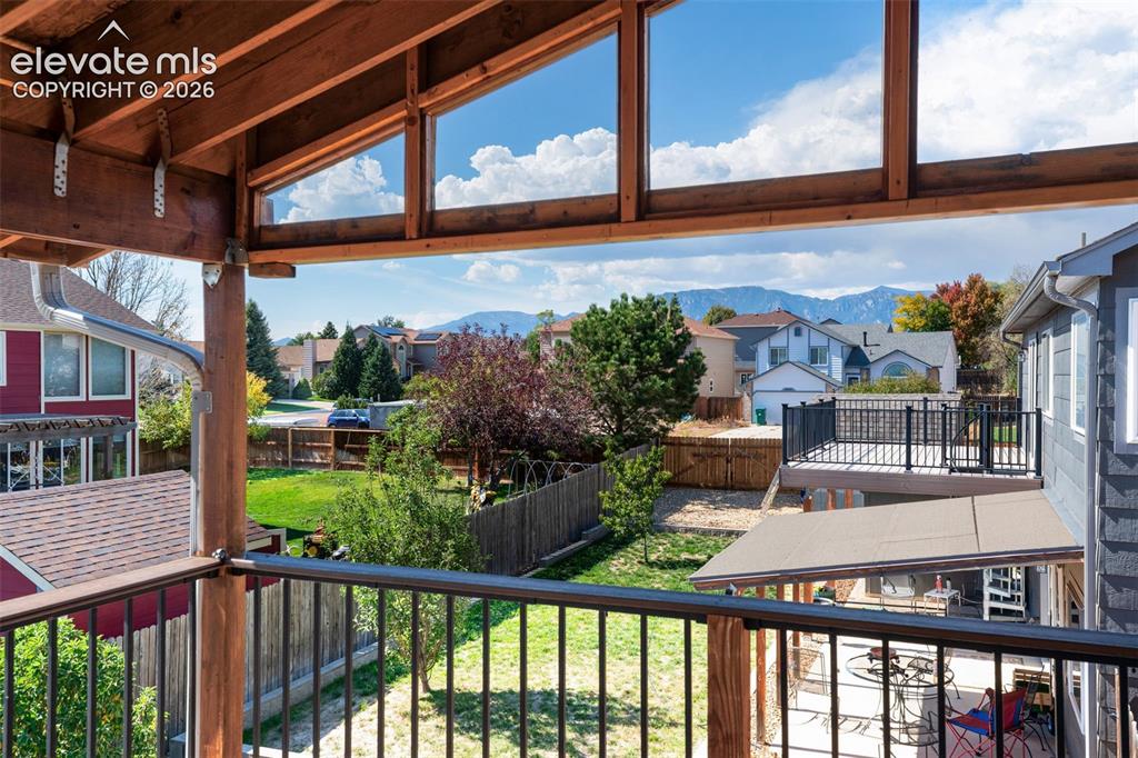 Image 46 of 48: Covered outdoor living space featuring exposed wood beams and framing