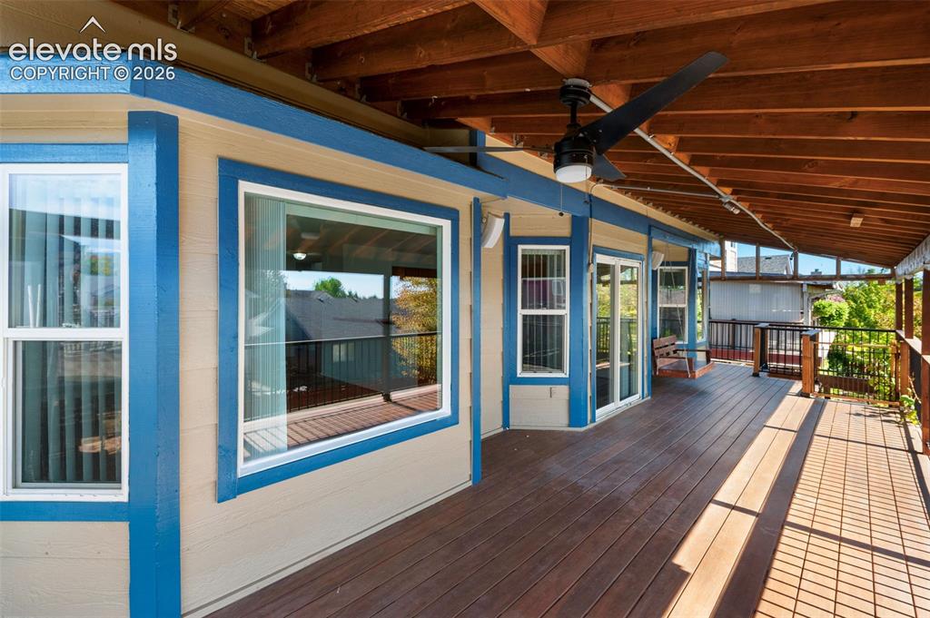 Image 47 of 48: Expansive covered deck featuring wood-finish flooring, exposed wood beam ce
