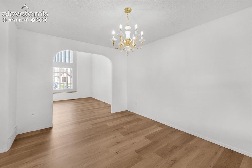 Image 7 of 48: Recessed lighting and a decorative chandelier illuminate the space, featuri