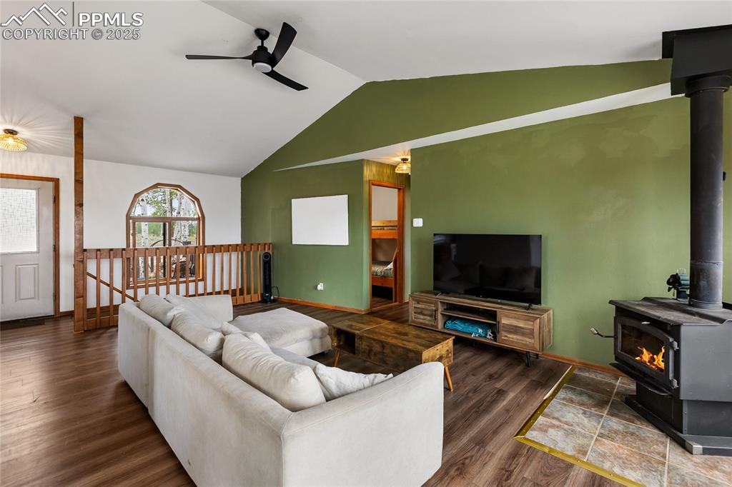 Image 11 of 50: Cozy living room off the kitchen with windows open to the back views.