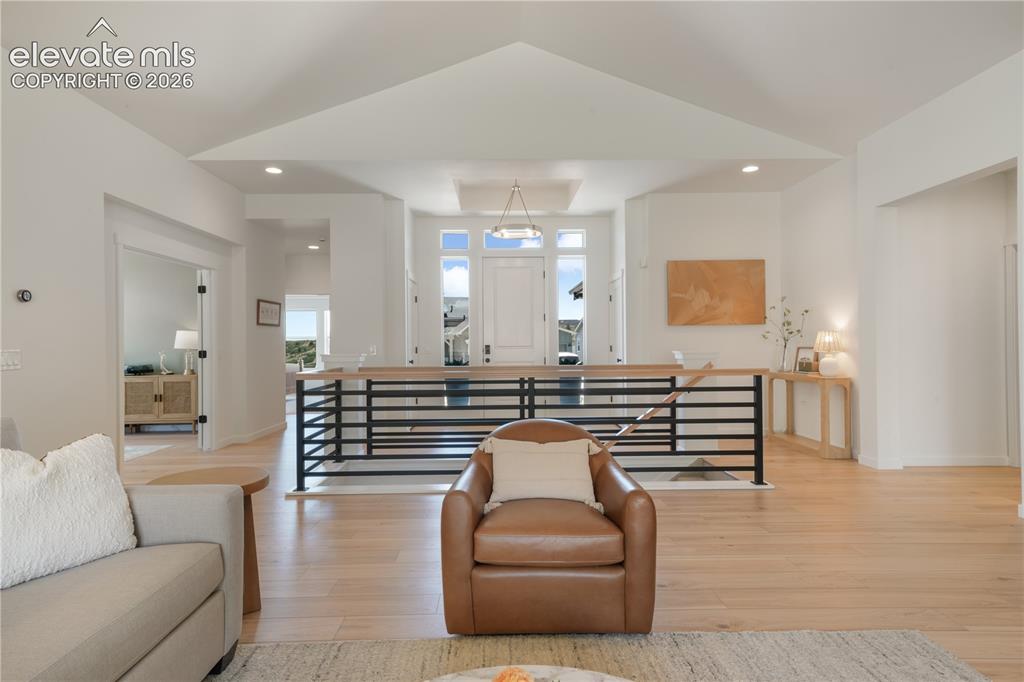 Image 4 of 50: LVP flooring and vaulted ceilings