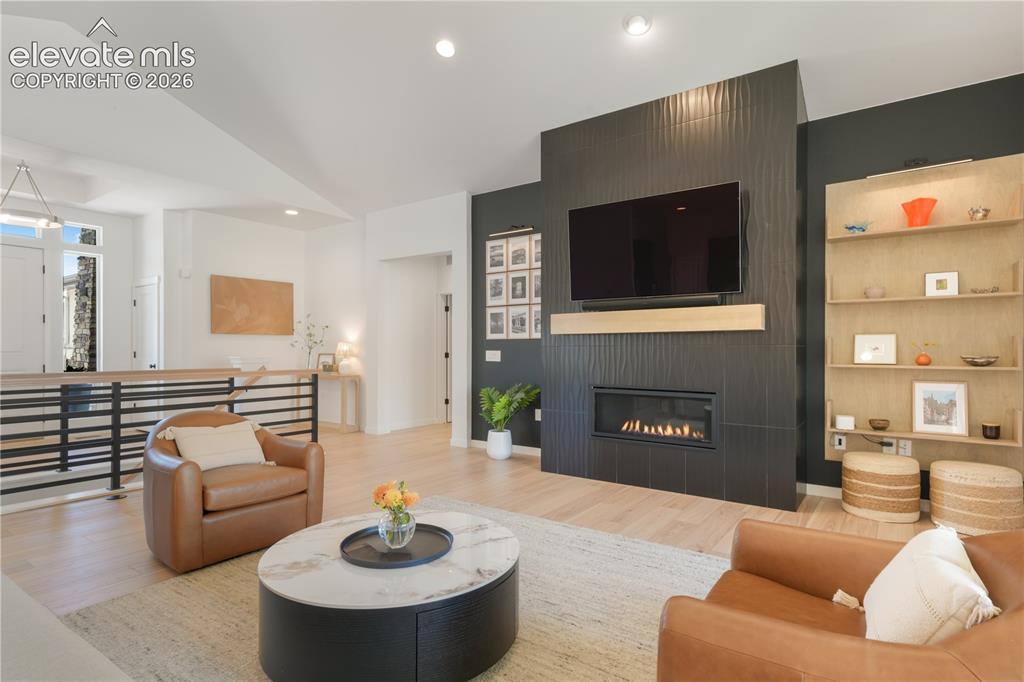 Image 6 of 50: Gas fireplace and stylish tile surround