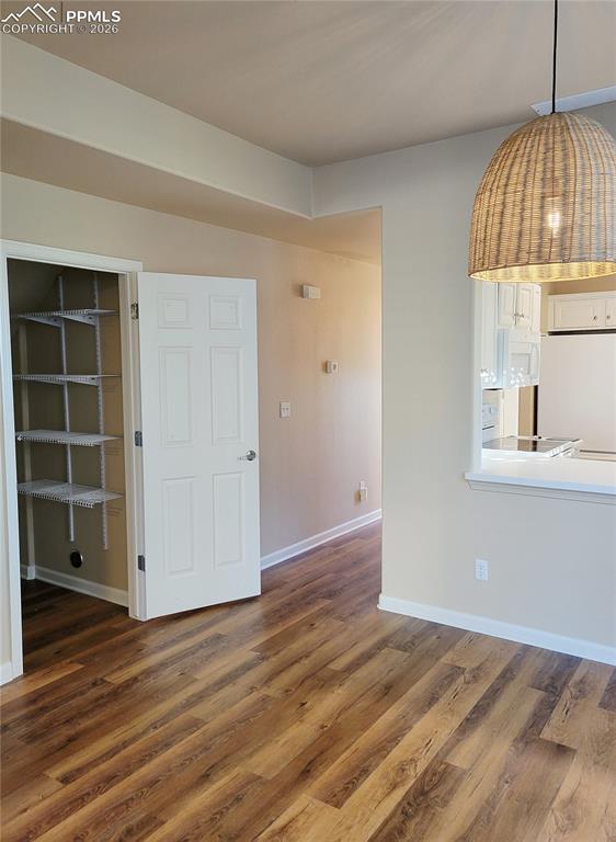 Image 11 of 38: Large pantry by kitchen and dining area (before furniture).