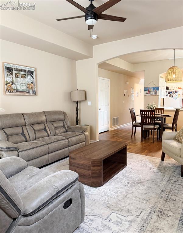 Image 12 of 38: Living room look back towards dining area.