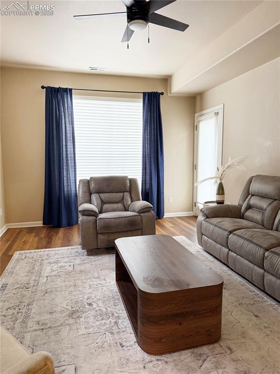 Image 13 of 38: Living room with fireplace and walk-out to back patio.