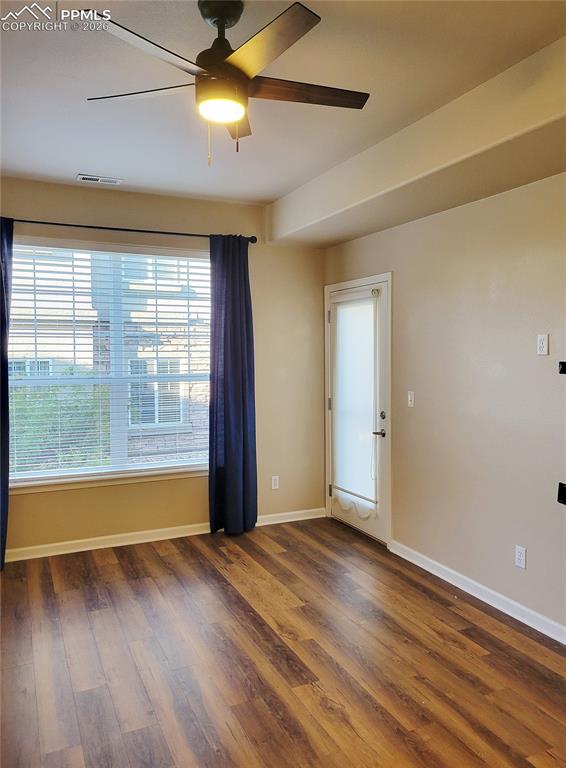 Image 14 of 38: Living room with fireplace and walk-out to back patio (before furniture).
