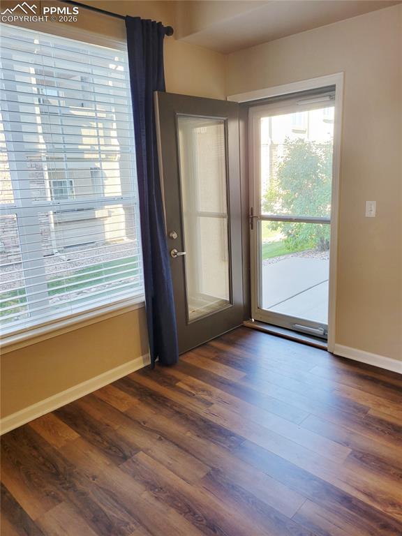 Image 15 of 38: Living room with fireplace and walk-out to back patio (before furniture).