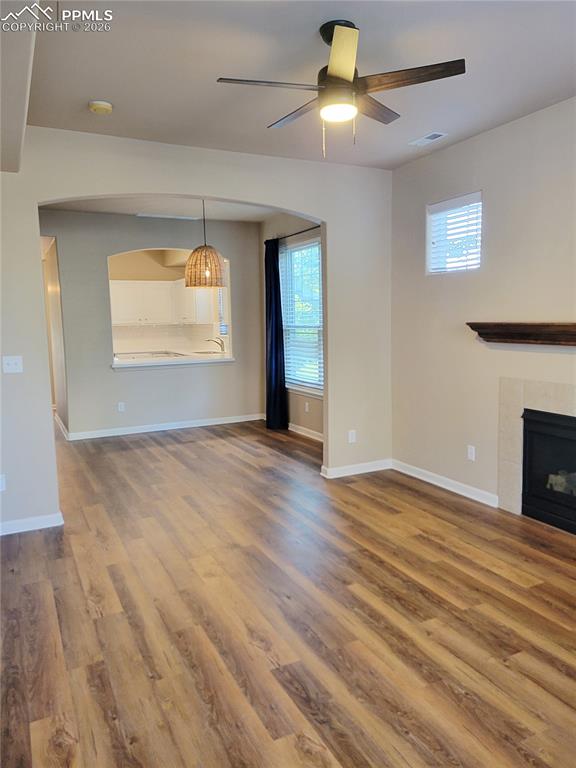 Image 16 of 38: Photo of living room looking towards dining area and kitchen (before furnit