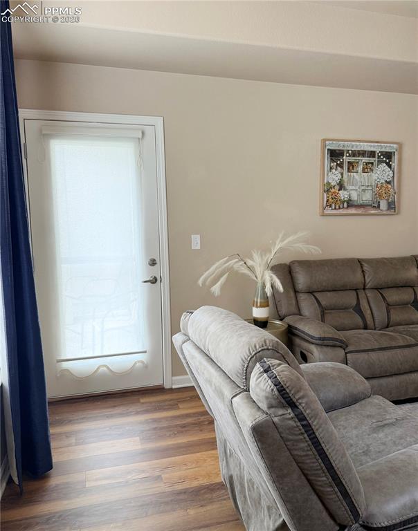 Image 18 of 38: Living room with walk-out to back patio.