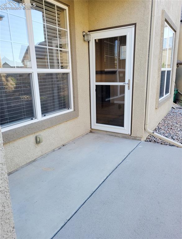 Image 19 of 38: Main level back patio.