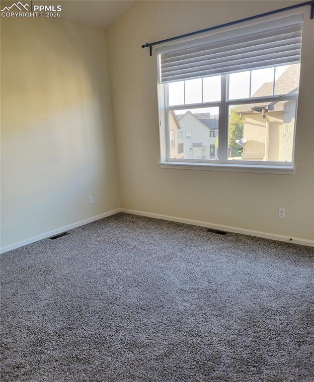 Image 23 of 38: Large primary bedroom upstairs with walk out to balcony patio.