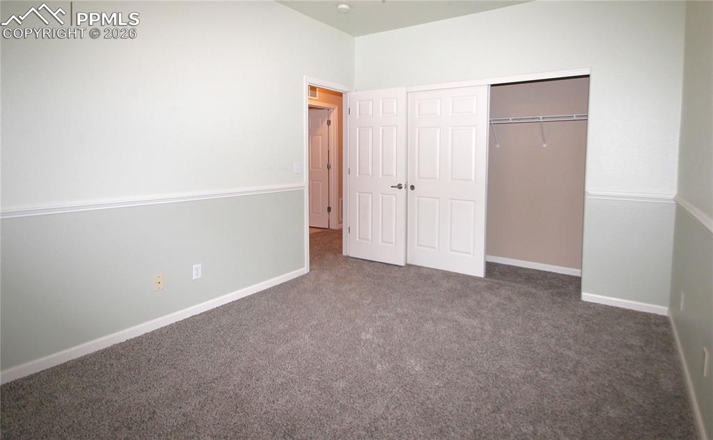 Image 28 of 38: Second upstairs bedroom with walk-out to Juliette balcony.