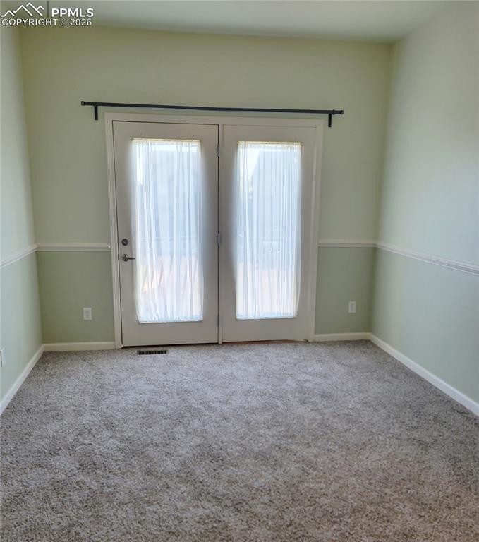 Image 29 of 38: Second upstairs bedroom with walk-out to Juliette balcony.