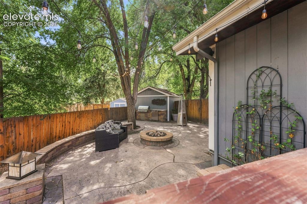 Image 28 of 36: Large patio with ample space to entertain and gas firepit.