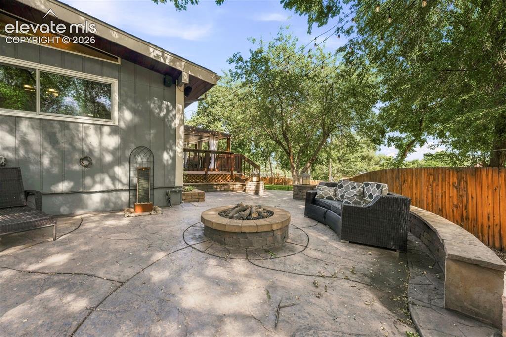 Image 29 of 36: Large patio area with gas fireplace.