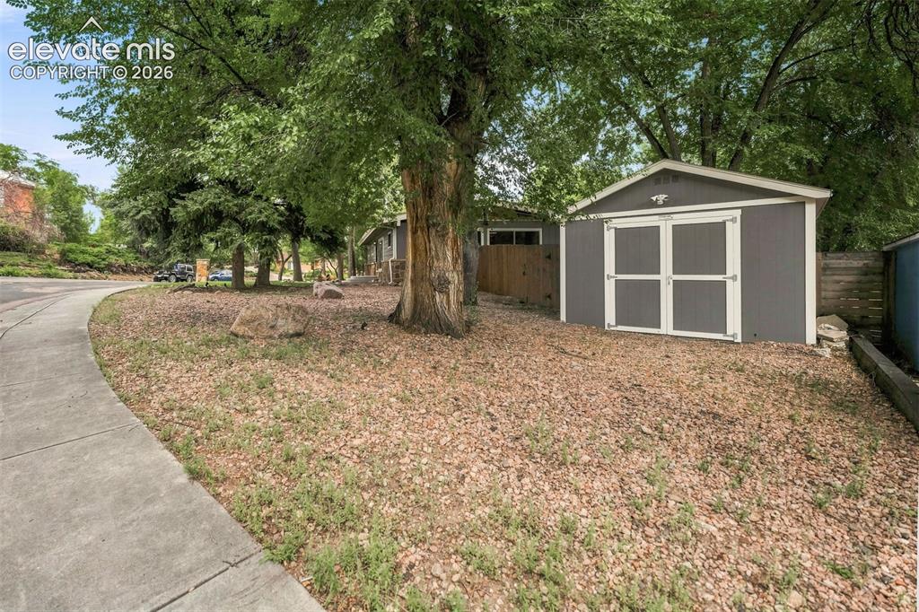 Image 4 of 36: Shed outside of the fence area near property line.