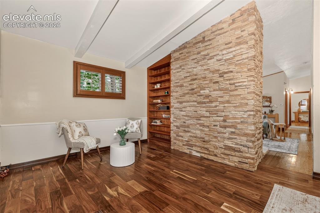 Image 7 of 36: Dining room sitting area on the other side of fireplace with built-in books