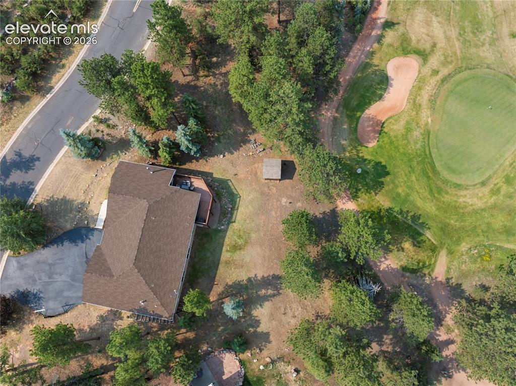 Image 45 of 48: Ground level looking towards backyard and golf course.