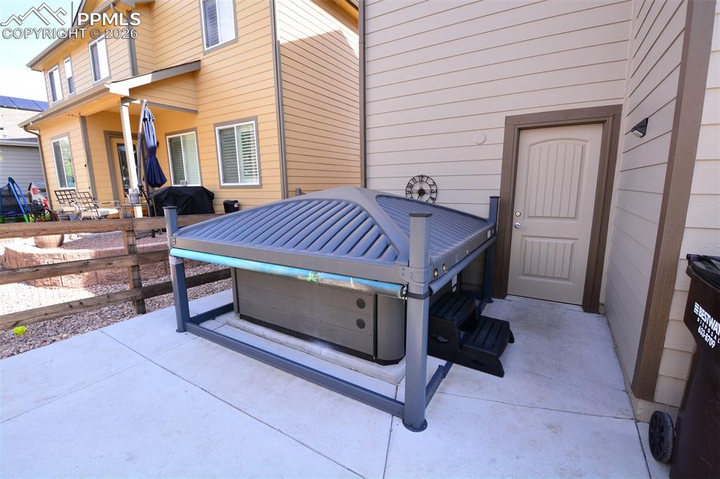 Image 29 of 30: Hot tub at rear of home