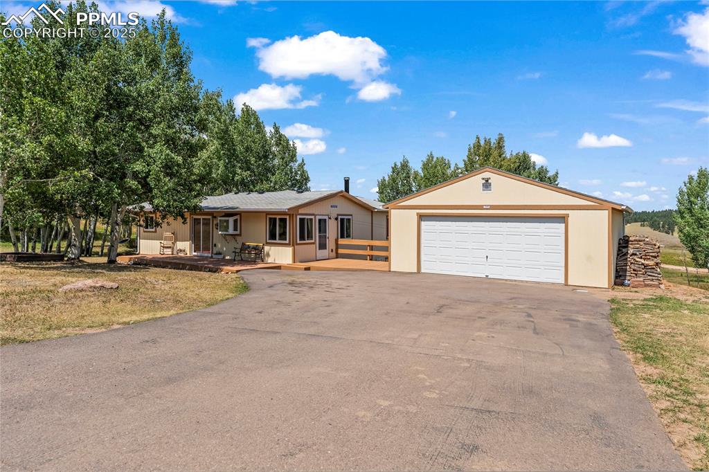 Caption: Ranch-style house with a detached garage.