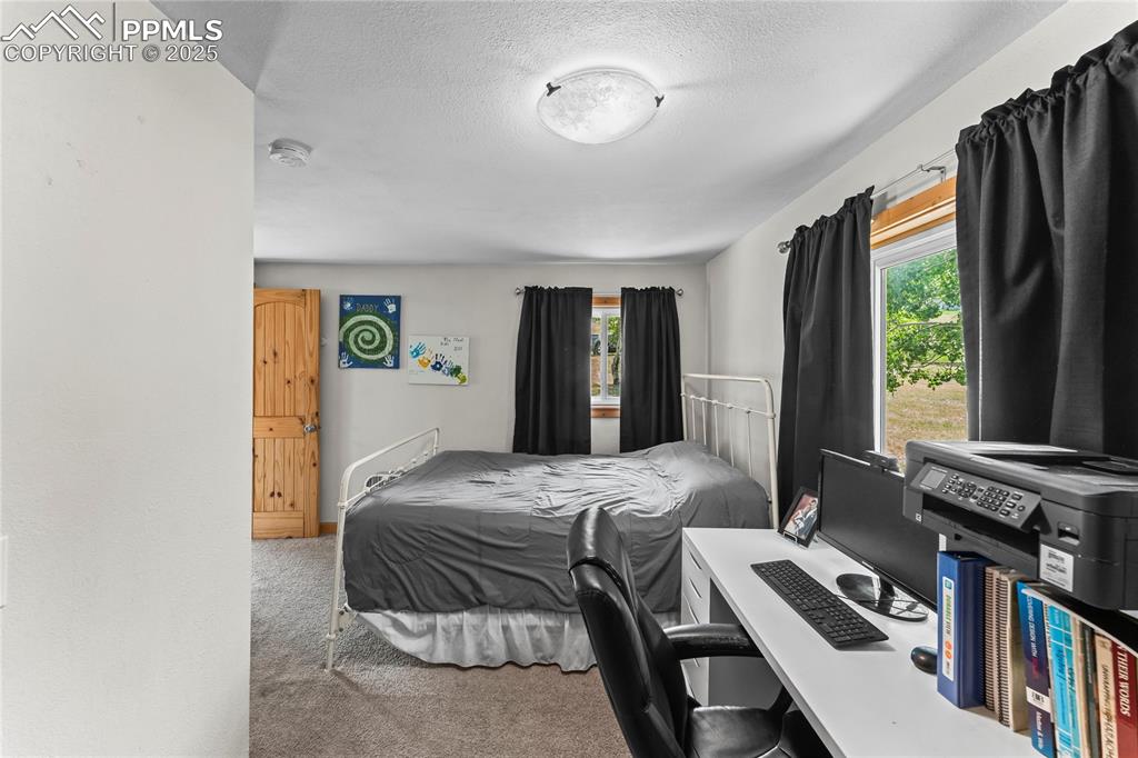 Image 14 of 30: Bedroom with light carpet and a textured ceiling
